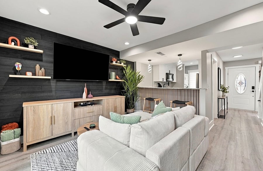 Living room with sectional sofa, Smart TV and wood accent wall