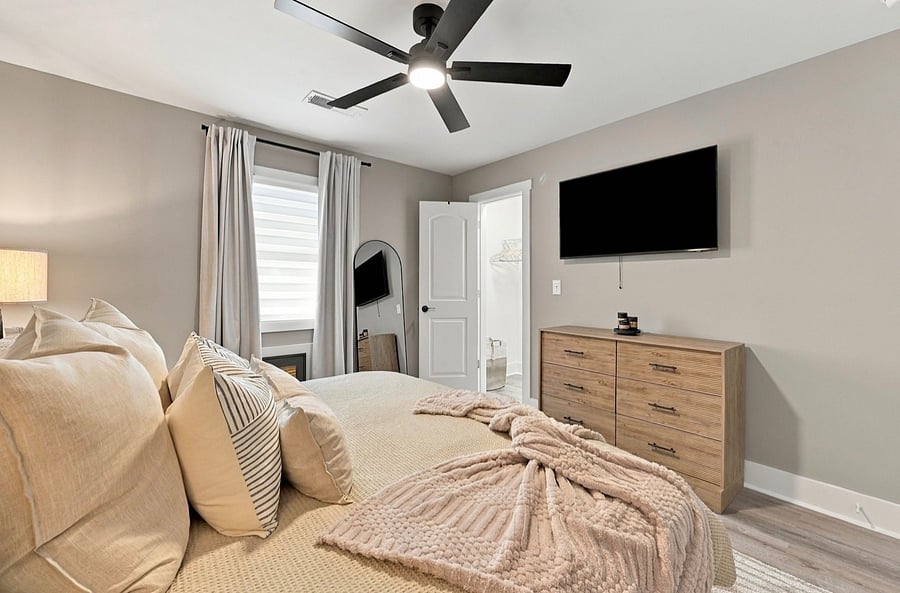 Primary bedroom with Smart TV and dresser