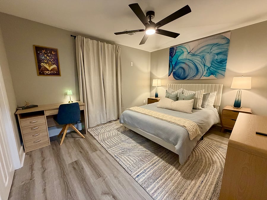 Second bedroom with queen bed and dedicated desk workspace