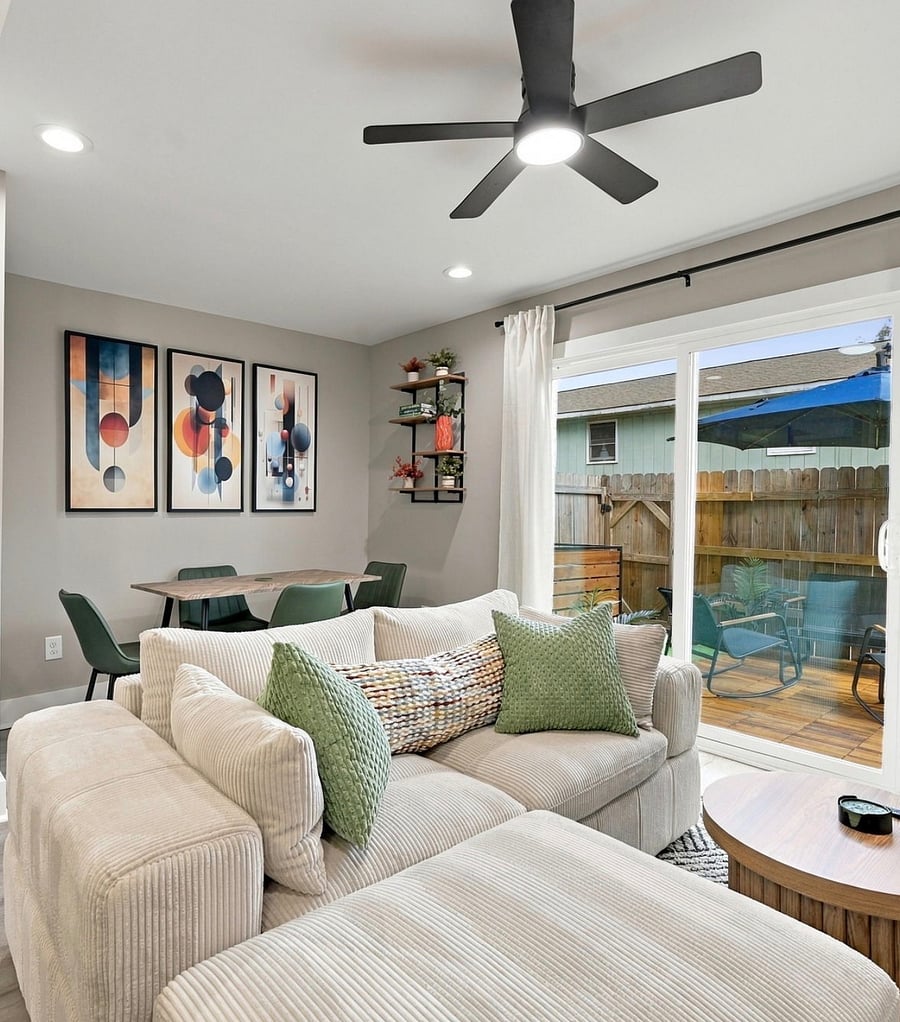 Furnished condo living and dining area with sliding door to the patio