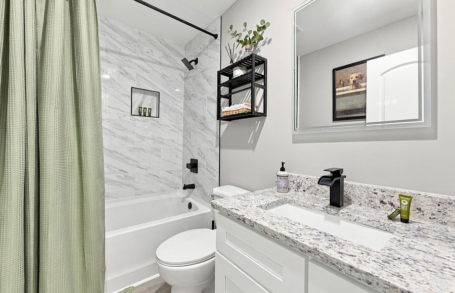 Second bathroom with tub and granite vanity