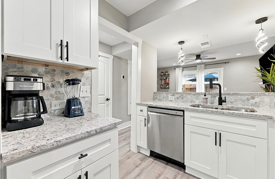 Fully equipped kitchen with stainless dishwasher and granite counters