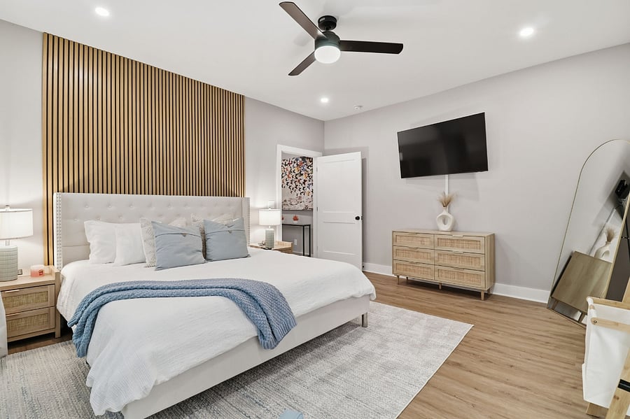 Bright primary bedroom with king bed in a furnished JAK Living home