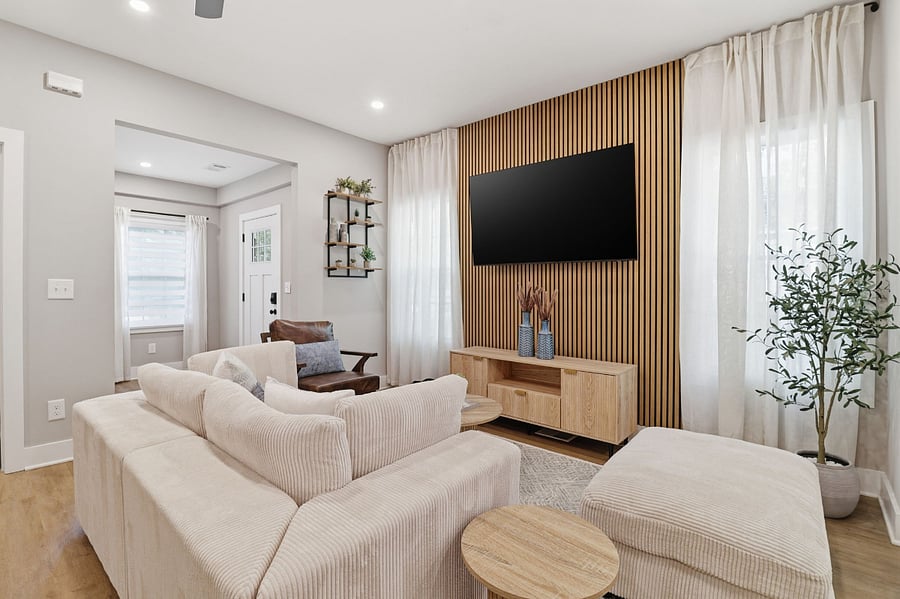 Bright living room with wood slat wall in a JAK Living home in East Point, GA