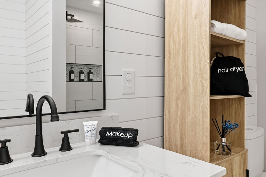 Primary bathroom vanity with black fixtures